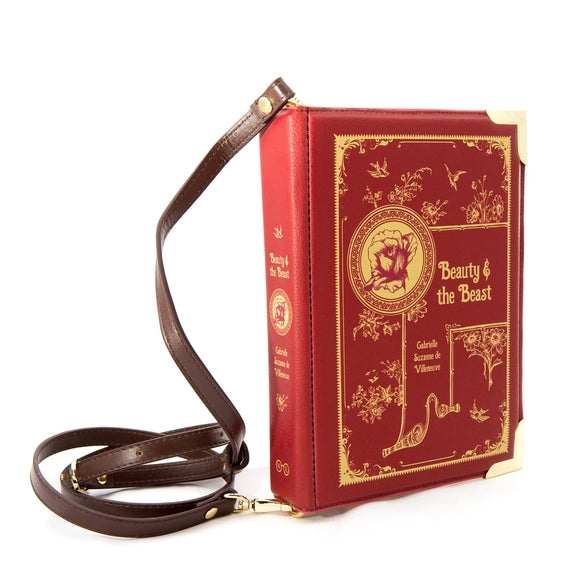 Voluptuous Vintage's Beauty and The Beast Book Bag, by Well Read Company. A deep red leatherette with gilt rose and floral decorations, resembling a hardback book. The strap attaches either end of the 