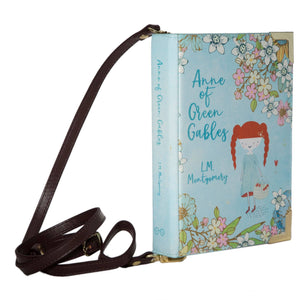 Anne of Green Gables Book Crossbody Handbag Bag by Well Read Company. a faux book with metal corners and straps attaching each end of the "spine". The cover features a cute cartoon version of Anne of Green Gables.