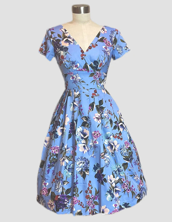 Voluptuous Vintage's Cindy Perfectly Periwinkle Dress by Retrospec'd. A pale blue with gorgeous floral print dress with short sleeces, a crossover bust and a defined waist panel above a swing skirt. 