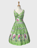 Voluptuous Vintage's Elizabeth Hampton Court Dress by  Retrospec'd. A retro style pink floral pattern with large border feature at the skirt on a pale green background featuring a crossover bust and full pleated skirt.