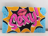 Voluptuous Vintage's Hand Beaded Luxury Pop Art Clutch Bag - "Sexy!" Bag by Rikki. A pop art inspired flash star on a blue and white dot background, with the word "sexy!" and a pair of lips boldly beaded in the centre.