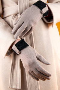 Voluptuous VIntage's Monica Wool Gloves by Powder. A light neutral colour with dark contrast textured band at the wrist. with a neutral tab and button cutting across it.