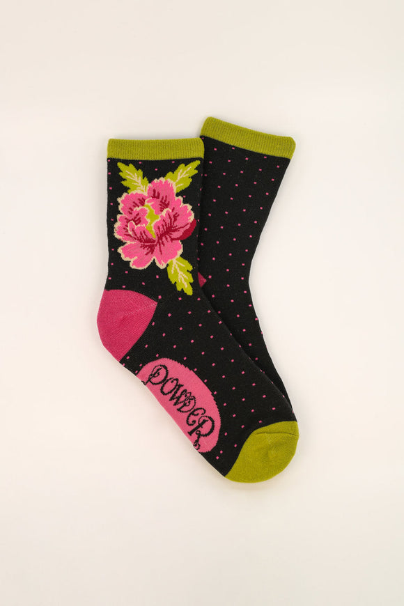 Painted Peony Ankle Socks with a dark grey background and bold pink peony design at the ankle. pink polkadots cover the sock and the cuff and toe are bright green