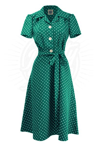 Sylvie 40s Polkadot Shirt Dress by Pretty Retro. A short sleeved shirtwaister dress with polkdots on a green background, and smart white buttons down the front.